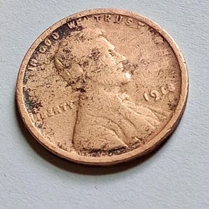 May include: A copper-colored United States one-cent coin featuring the profile of Abraham Lincoln facing right. The text IN GOD WE TRUST is arched along the top edge, the word LIBERTY is on the left, and the year 1948 is printed on the right side.