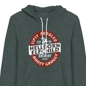 May include: A dark gray hooded sweatshirt with a red circle logo that says "Tipsy,  Ruddled, Est. '89, Hellborn Elfchild Brewery, Vermont, Boozy, Groggy".