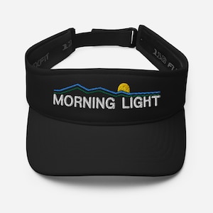 May include: Black visor with a white embroidered design of mountains, a sun, and the text "MORNING LIGHT".