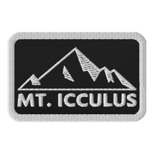 May include: A black and white embroidered patch with a mountain range design and the text "MT. ICCULUS".