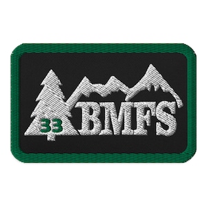 May include: Green and white embroidered patch with a mountain range and a pine tree with the number 33 on it. The text "BMFS" is embroidered in white.
