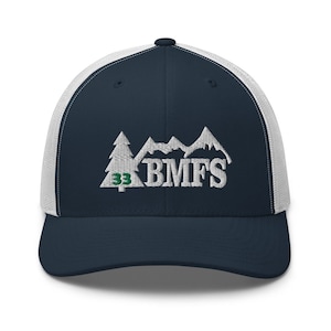 May include: A navy blue and white trucker hat with a white embroidered design of mountains and trees. The text "BMFS" is embroidered in white and the number "33" is embroidered in green.