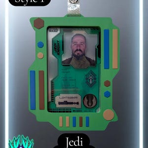 May include: A green rectangular badge holder featuring the text Style 1 and Jedi Knight. The holder displays a Star Wars Jedi Knight identification card with a portrait, the text Jedi Knight, Rank: Knight, Faction: Jedi Order, and Lightsaber.