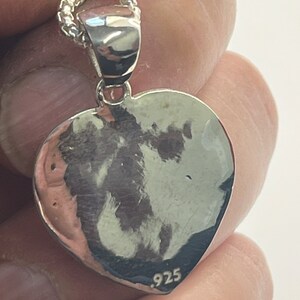 May include: Silver heart pendant necklace with a .925 stamp on the back.