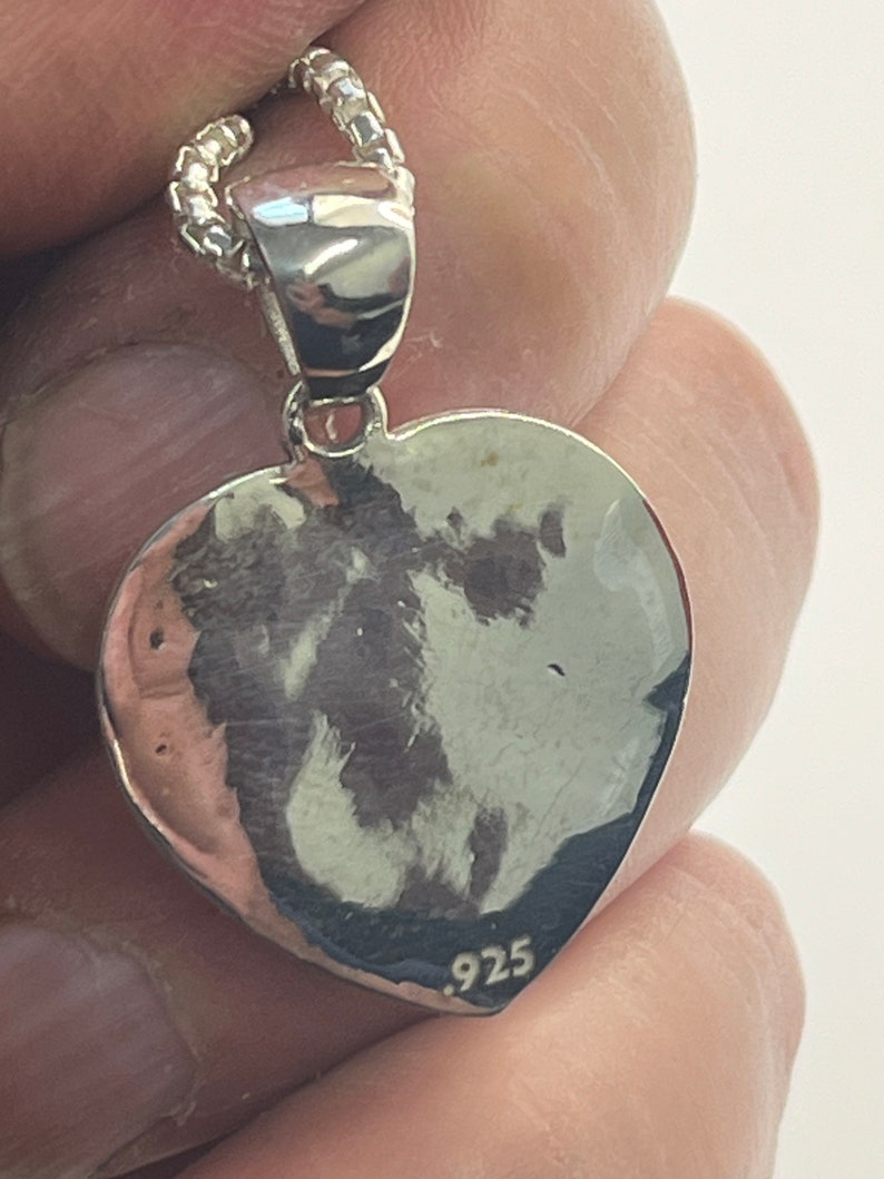 May include: Silver heart pendant necklace with a .925 stamp on the back.