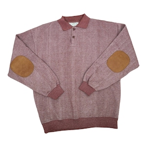 May include: A long-sleeved, burgundy sweater with a textured pattern. The sweater has a collared neckline, a button placket, and brown leather elbow patches. The sweater has the word "Orvis" printed on the collar.