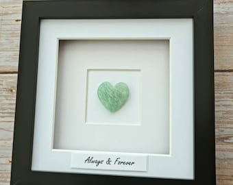 May include: A framed heart-shaped green stone with the text "Always & Forever" on a white background.
