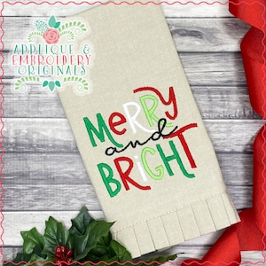 May include: A beige fabric kitchen towel with the text "Merry and Bright" embroidered in green, red, and white lettering. The text is in a playful, handwritten style.