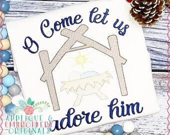 May include: Embroidered design of a manger scene with the text "O Come Let Us Adore Him".