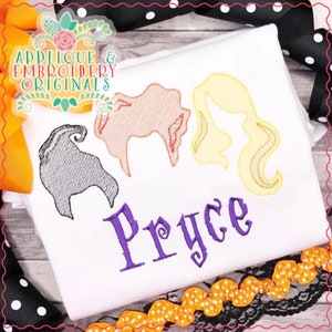 May include: A white t-shirt with an embroidered design of three witch silhouettes in orange, yellow, and black. The name "Pryce" is embroidered in purple below the silhouettes.