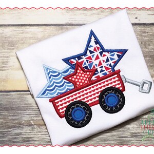 May include: Red, white, and blue stars are piled in a red wagon with blue wheels. The wagon has a white handle. The stars are made of different patterned fabrics.
