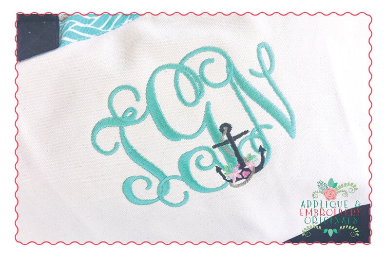 May include: A teal blue embroidered monogram with the letter "A" and an anchor with flowers. The anchor is black with pink and white flowers. The background is white.