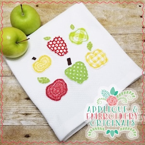 May include: White kitchen towel with applique embroidery of red, green, and yellow apples. The text "Applique & Embroidery Originals" is at the bottom of the towel.