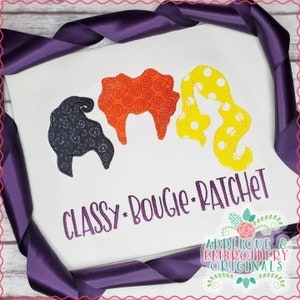 May include: Embroidered design featuring three witch silhouettes with different patterned hair, with the text "CLASSY.BOUGIE.RATCHET" below. The design is on a white fabric background.
