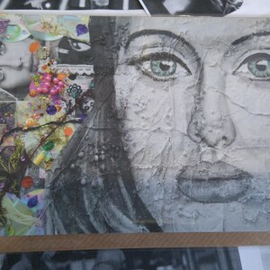 May include: A collage card featuring a woman's face with textured paint and a close-up of a woman's eye. The background is a collage of colorful paper, beads, and glitter.