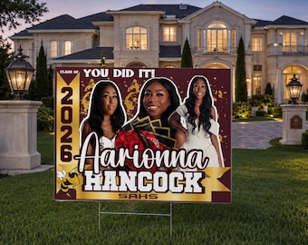 May include: A graduation yard sign with the text "YOU DID IT!" and "2026". The sign features three young women and the name "Aarionna Hancock" with "SAHS" below. The sign is brown, gold, and white.