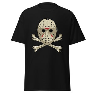 May include: Black t-shirt with a white hockey mask and crossed bones graphic. The mask has red accents and a distressed look.