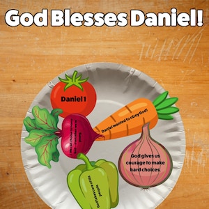 May include: A white paper plate featuring illustrations of a red tomato labeled Daniel 1, a carrot labeled Daniel wanted to obey God, a beet labeled We can choose to honor God even when we're young, a green pepper, and an onion with text.