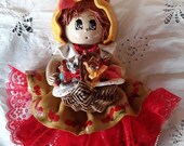 Giant handmade doll and its family of cats