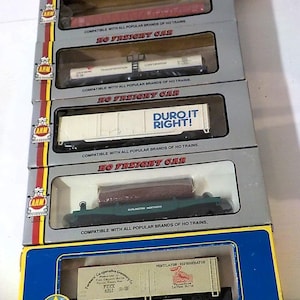 May include: A set of three ceramic mugs with a speckled, matte finish. The mugs are in shades of cream, light gray, and dark gray. Each mug has a simple, minimalist design and a rounded handle.