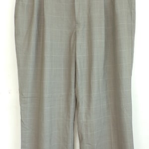 May include: Gray plaid pants with a pleat detail and cuffed hems.