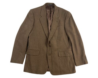 May include: A brown and black plaid blazer with a single button closure. The blazer has a notched lapel and two flap pockets.