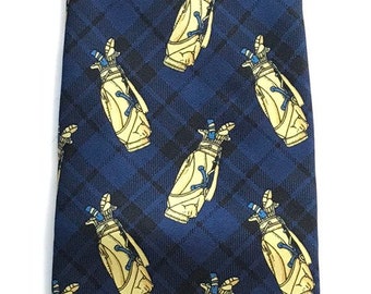 May include: A blue silk tie with a repeating pattern of yellow golf bags. The golf bags have blue and white accents.