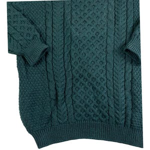 May include: A dark green cable knit sweater with a textured pattern. The sweater has a crew neck and long sleeves.