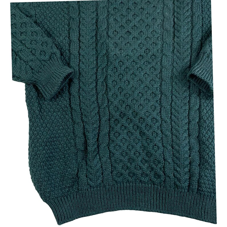 May include: A dark green cable knit sweater with a textured pattern. The sweater has a crew neck and long sleeves.