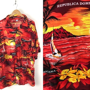 May include: A red, orange, and yellow Hawaiian shirt with a sunset and palm tree print. The shirt has the text "Republica Dominicana" printed on it.