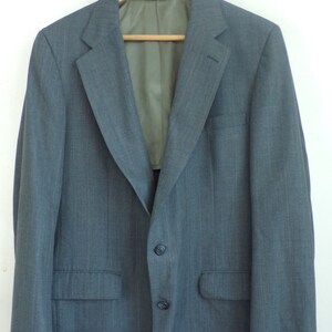 May include: A gray pinstripe blazer with a single button closure and two flap pockets.
