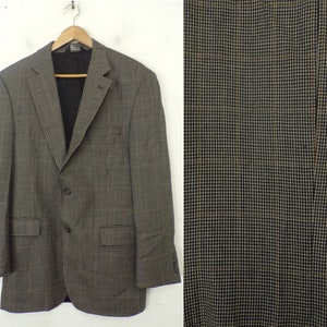May include: A brown and black patterned blazer with a two-button closure. The blazer has a classic fit and a single vent in the back.