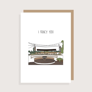 May include: A white card with the text "I fancy you" and a black and white illustration of a patio with string lights, a fire pit, and seating.