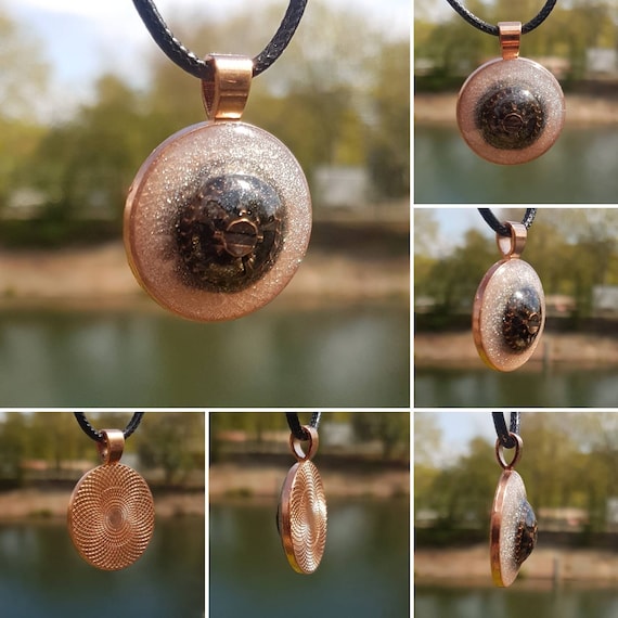 Necklace with pendant made of epoxy resin. Round amulet in rose gold with bronze gear in silver cloud.
