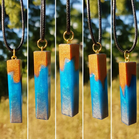 Necklace with pendant made of epoxy resin - metallic blue meets metallic gold - shape of elongated cuboid slightly twisted