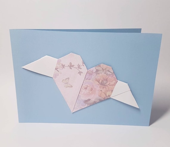 Light blue folding card with floral origami heart with white wings