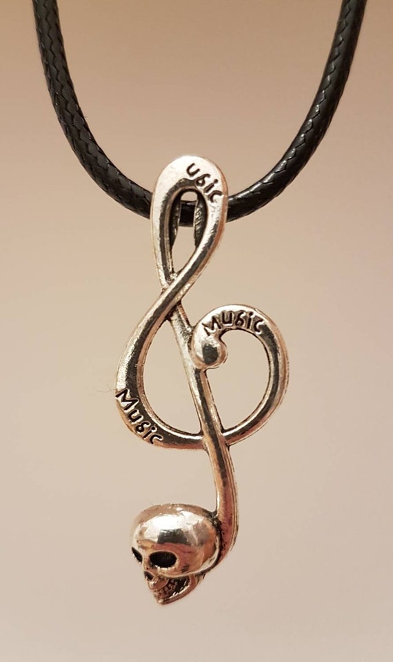 Black chain with silver note key and skull as pendant