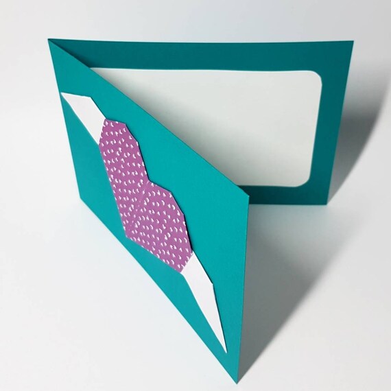 Folding card in dark turquoise with purple origami heart with small white hearts