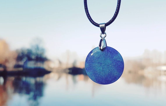 Necklace with pendant made of epoxy resin metallic: the depths of space in deep blue and purple with stardust