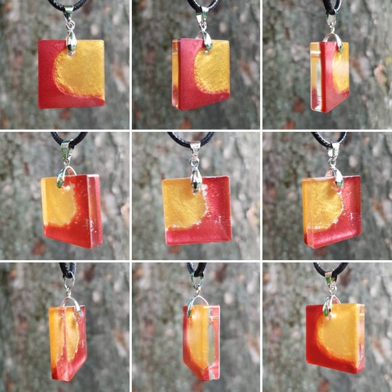 Necklace with square pendant made of epoxy resin - red meets gold - with silver sparks