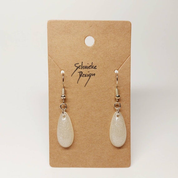 Earrings made of epoxy resin in metallic silver