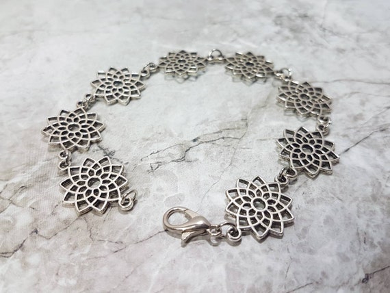 Silver bracelet with geometric mandala flowers
