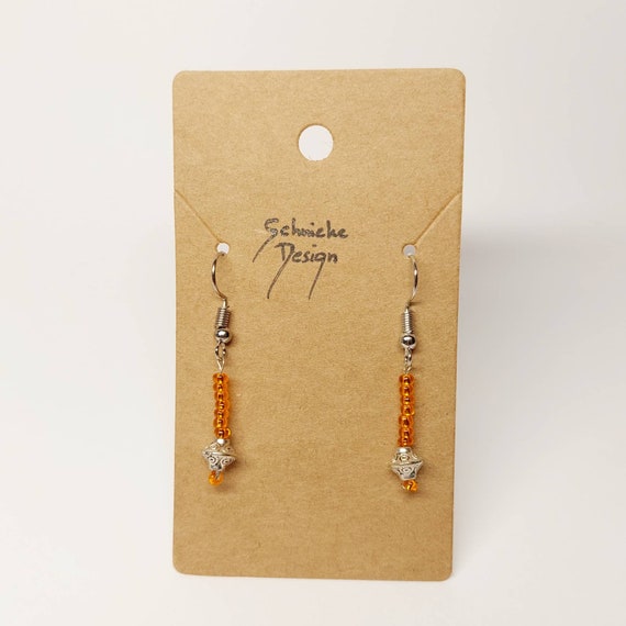 Earrings made of orange and silver beads