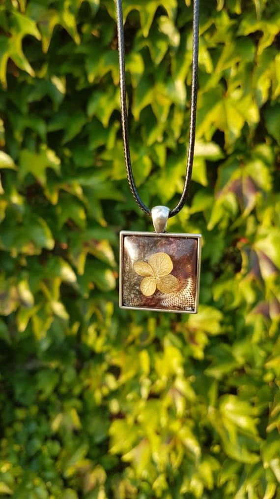 Necklace with pendant - amulet with flower in metallic black-purple and transparent epoxy resin cast and square setting in silver