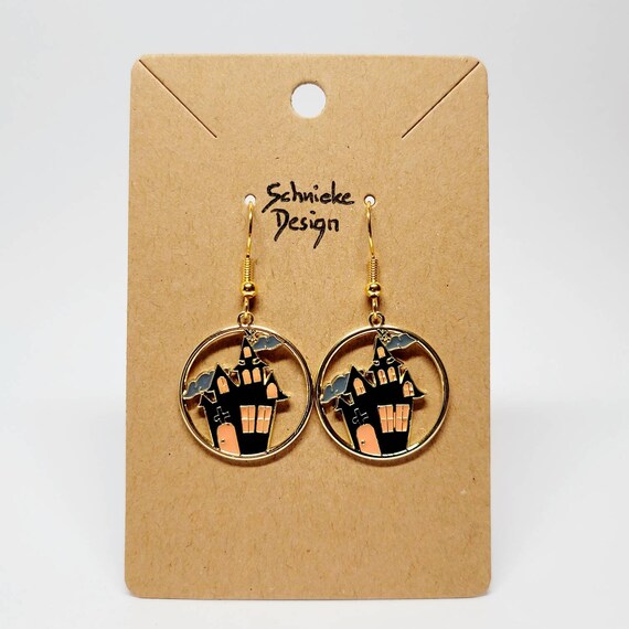 Earrings with a small witch's house