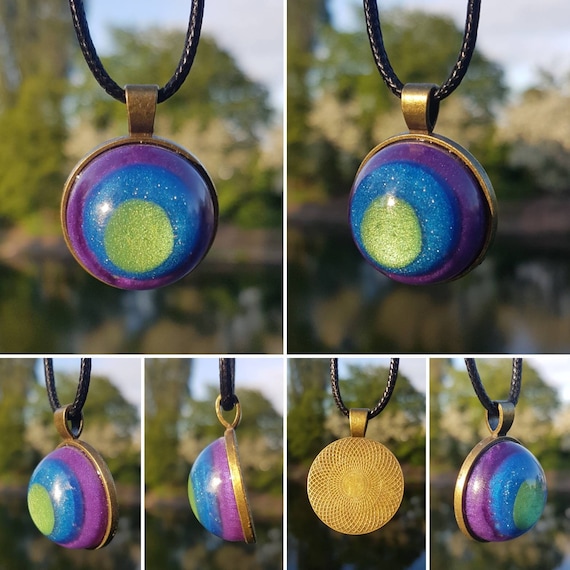 Necklace with round amulet pendant: metallic epoxy resin cast in green, blue, and purple circles - setting in antique bronze / antique gold