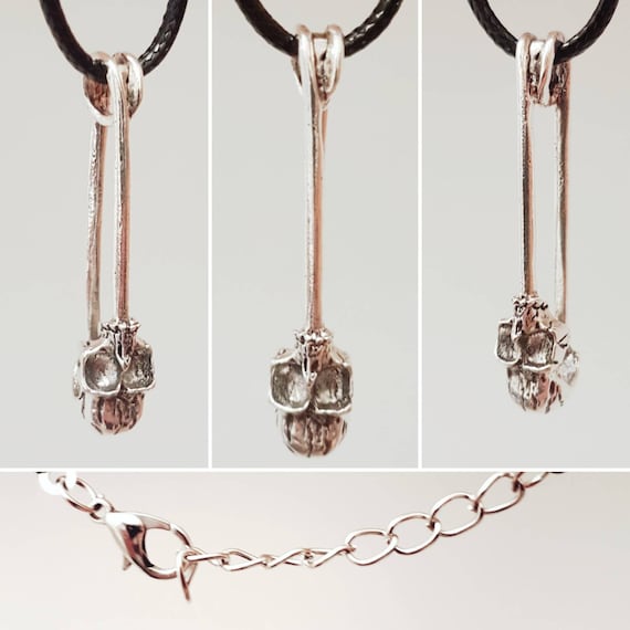 Black chain with silver safety pin and skull as pendant