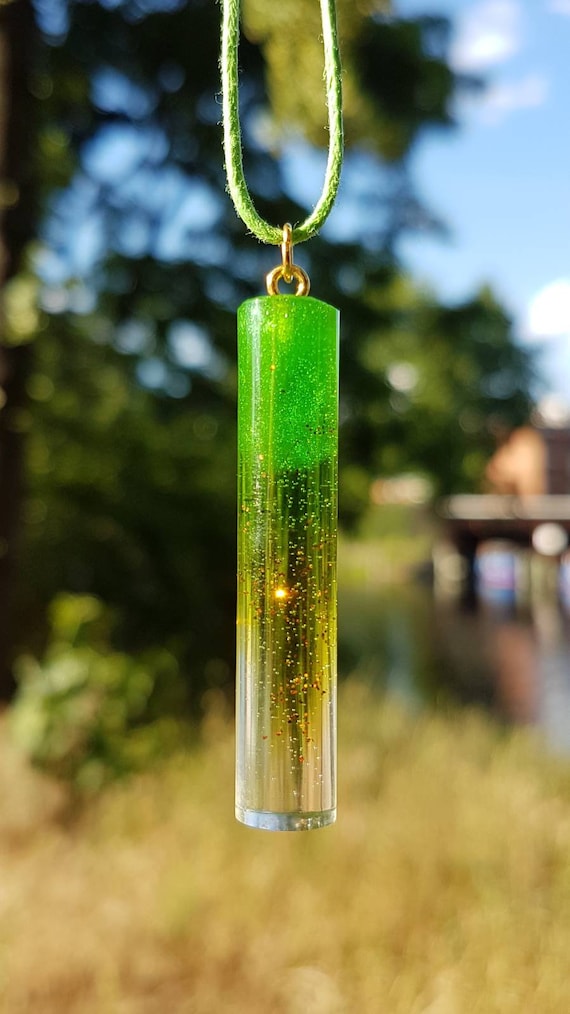 Necklace with handmade pendant made of epoxy resin - metallic green and copper-colored glitter particles in transparent epoxy - cylinder shape