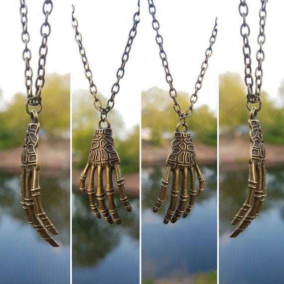 Necklace with pendant in antique gold - large bony skeleton hand