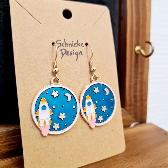 Earrings with a rocket in space made of enamel